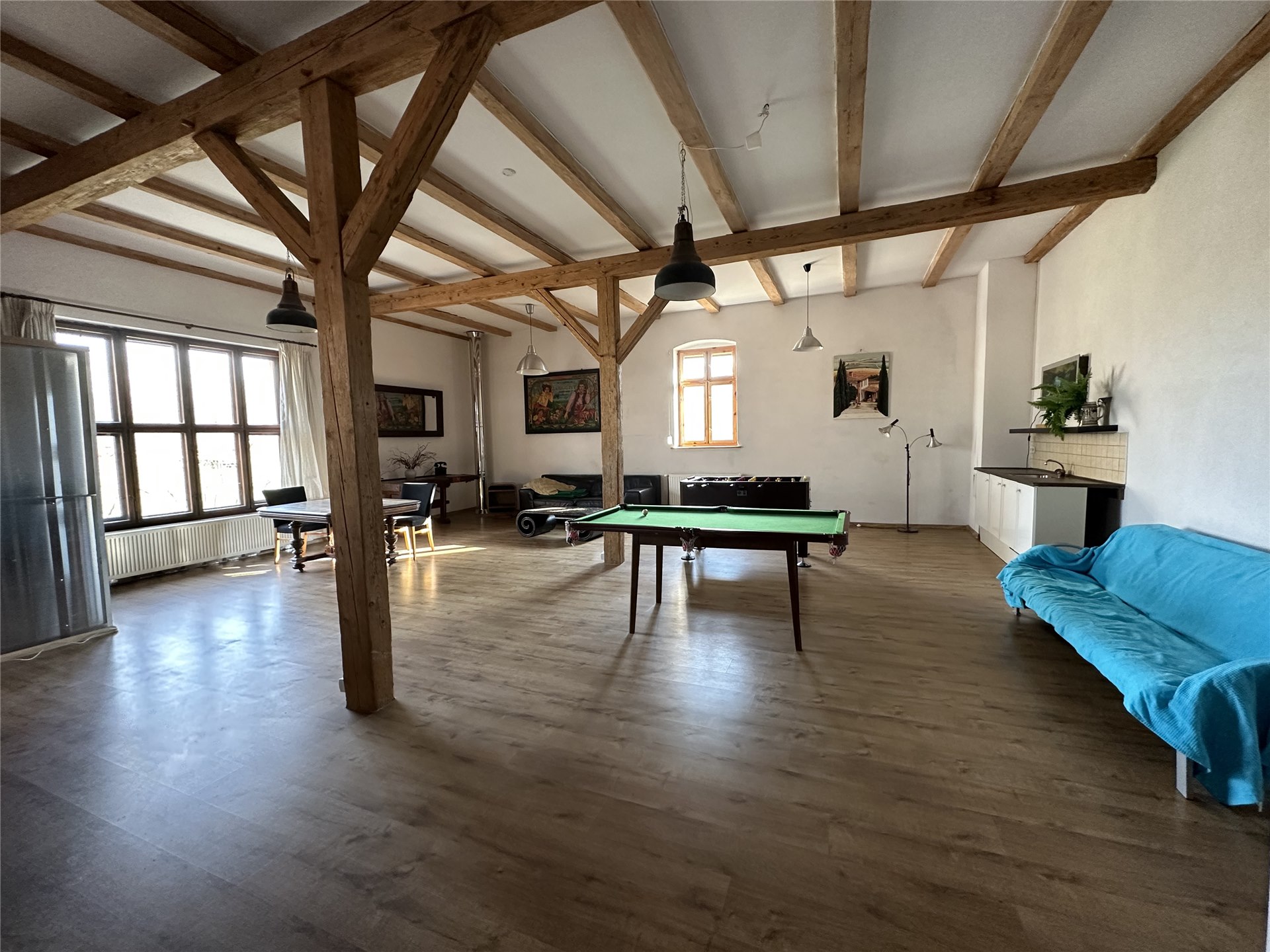 The large room at Domstolat with wooden beams, plenty of daylight and a pool table, also used for yoga