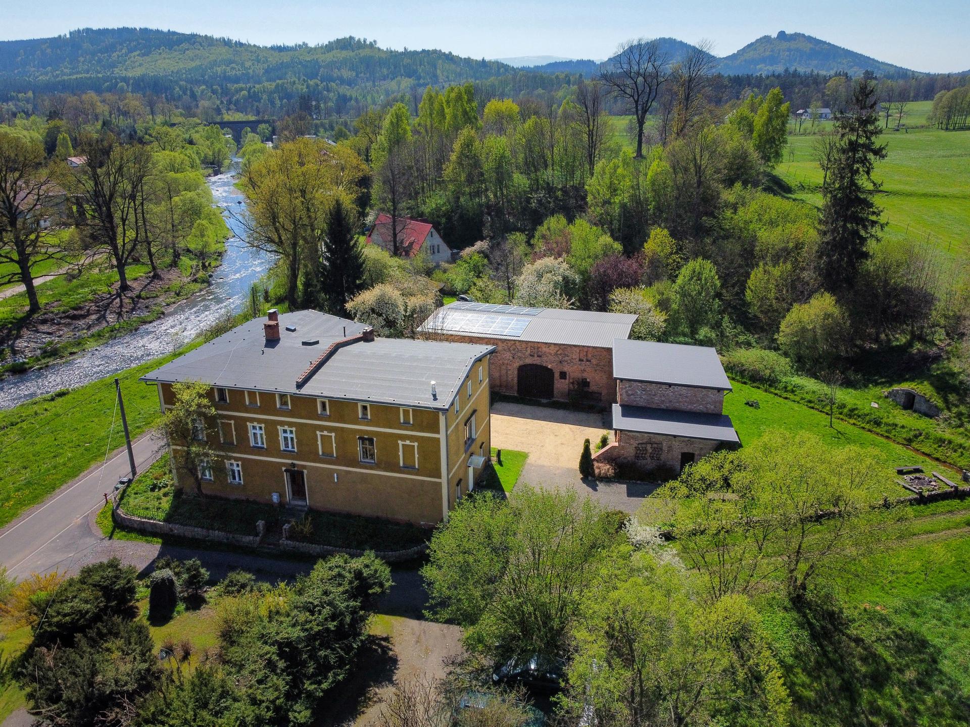 Aerial view of Domstolat country house with the River Bóbr, meadows and hills in Lower Silesia